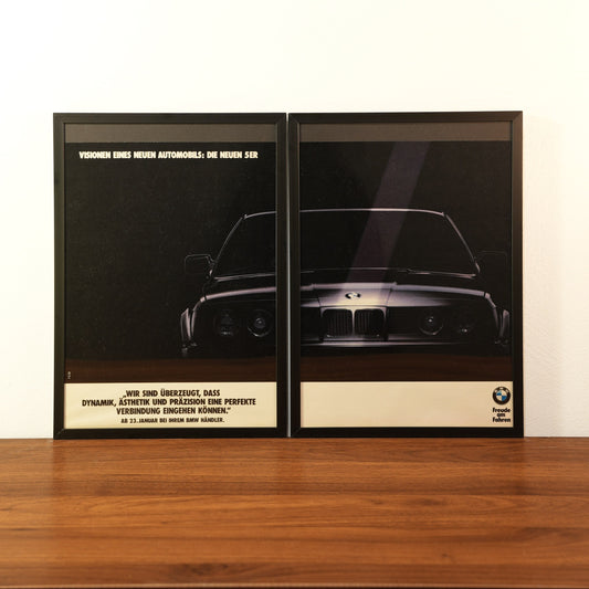 Original vintage BMW 5 Series advertisement framed in black aluminum. Two-piece wall art set showing the dark silhouette and headlights of the new BMW 5er with the German slogan 'Visionen eines neuen Automobils'.