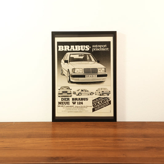 Original vintage Brabus Autosport advertisement framed in black aluminum. Single wall art piece showing a tuned Mercedes-Benz W124 sedan with the German headline 'Der Brabus Neue W 124'.